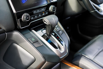 automatic transmission shift selector in the car interior. Closeup a manual shift of modern car gear shifter. 4x4 gear shift