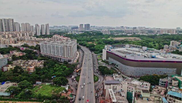 nexus mall circle kphb, hyderabad, telangana with flyover roads and buildings  aerial view  pull away drone shot