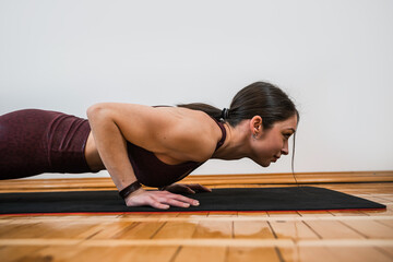 Fototapeta na wymiar Caucasian slim female trainer show how to do it right streching exercise
