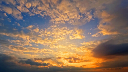 Naklejka na ściany i meble beautiful sunset gold clouds on the sky background - photo of nature