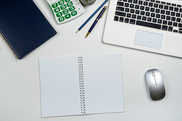 Top view of office workplace desk with laptop pen on notebook