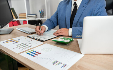businessman work on laptop computer for accounting  financial data annual report graph and diagram