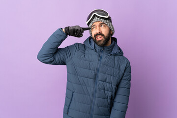 Skier man with snowboarding glasses over isolated purple background making the gesture of madness...