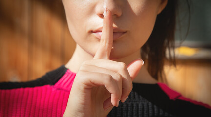 Naklejka premium Female finger on her lips. Silence
