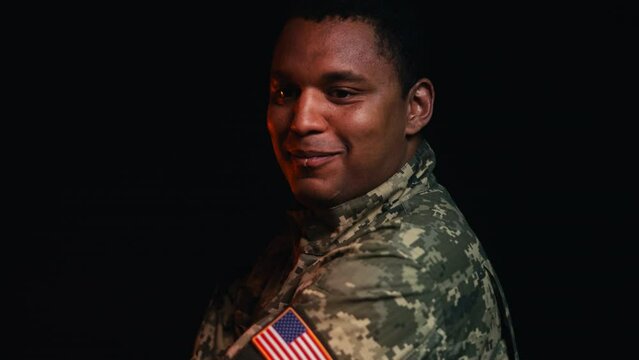 American soldier smiling crossing arms on chest, USA patch on military uniform