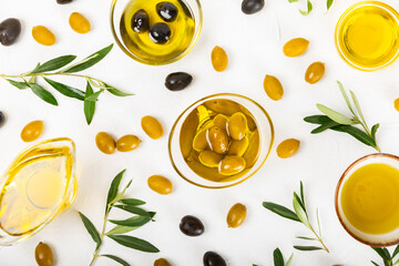 Olive oil in a bottle on texture background. Oil bottle and a bowl with branches and fruits of olives. Place for text. copy space. cooking oil and salad dressing.