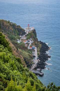 Viewpoint for Ponta do Arnel Lighthouse in seascape cliff with winding road by the sea, São Miguel - Azores PORTUGAL