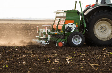 Obraz premium Tractor and seeder for sowing corn