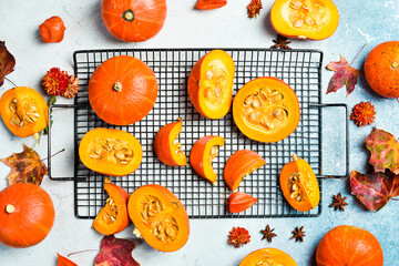Autumn card with pumpkins. Orange pumpkins on white planks, holiday decoration. Set of pumpkins. Organic food. Top view.