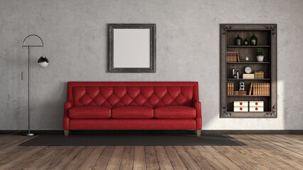 Red sofa in an old room with wooden bookcase embedded in the wall