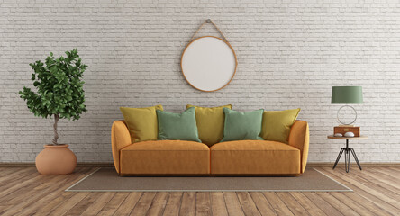 Modern sofa in room with white brick wall