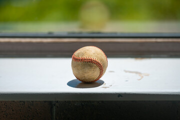 Old baseball ball on the windowsill, copy space.