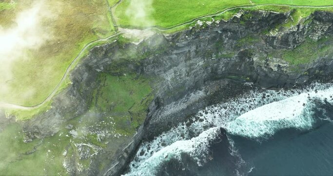 Flying in the clouds above the Cliffs of Moher in 4k