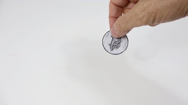 Popular cryptocurrency most famous coin in the world bitcoin in hand.