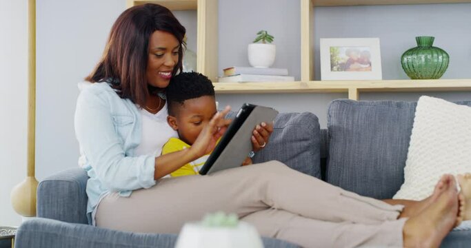 Child, mom and smile with tablet on sofa to play video games, watch movies and elearning app for kids at home. Mother, boy kid and black family streaming cartoon, digital ebook story or social media
