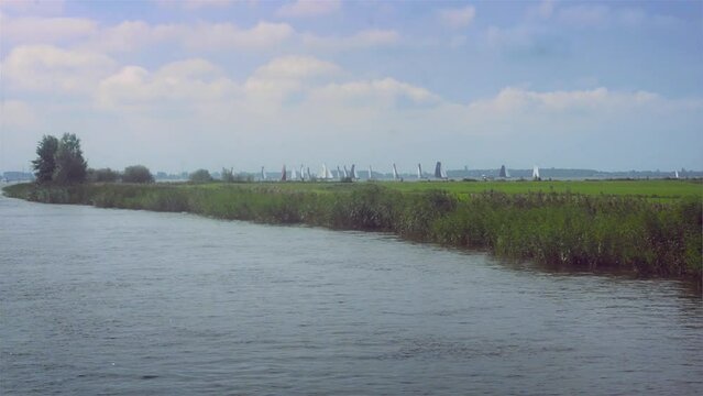 Pastoral countryside with sail boats.