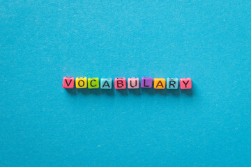 vocabulary word, learn language concept with multicolored letters on blue