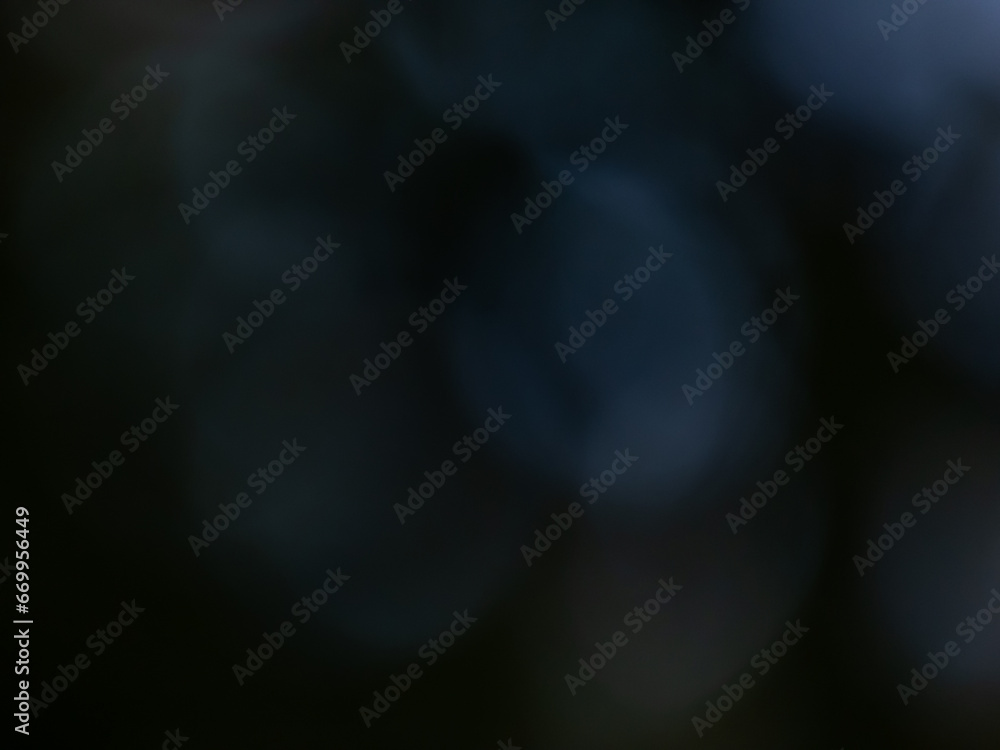 Wall mural black and dark blue bokeh effect and purposely blurred view. dark background with photographic bokeh
