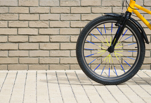 Background with bicycle at city street riding along brick wall