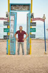 Creative decoration in the seaside cafe in Dahab: old wooden doors and wings in front of the sea, Dahab, Egypt