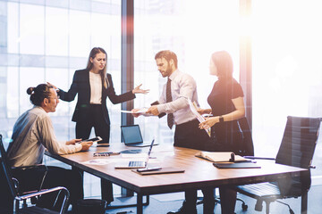 Full length view of business people collaborating around table