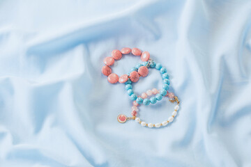 bracelets made of natural stones on blue silk fabric