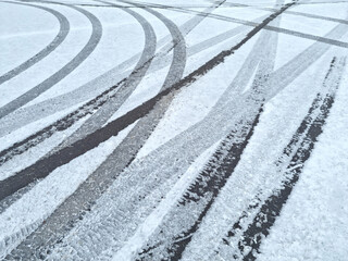 Dynamic car tread marks on the snow. Early winter. Energy and expression of movement. Black and...