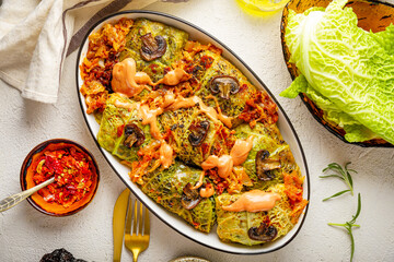 Savoy cabbage stuffed with mushrooms top view, vegetarian dish, white background