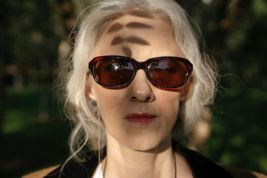 Mature woman with sunglasses at park