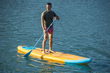 Man on sub board floating on ocean sea.