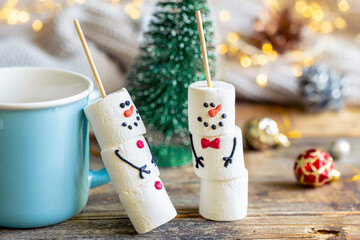 Hot chocolate mug and a snowmen made of marshmallows.