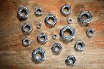 Metal nuts group on a wood table