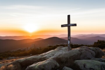 christian cross on top of a mountain with sunrise in background