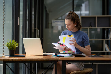 Businesswoman working hard with a lot of documents, searching and checking information