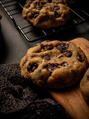 Cookies are arranged messily on a wooden placemat, isolated with a wooden table background.