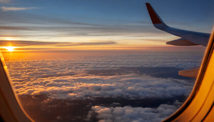 Naklejka na ściany i meble view from airplane window seat overlooking sunset horizon and clouds