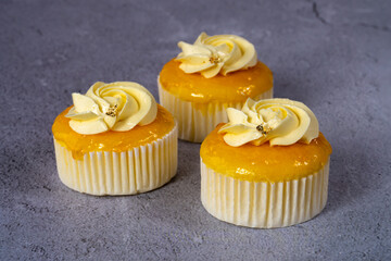 cupcake with cream on grey cement background.