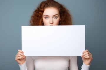 A young lady showcasing a white banner with no content.