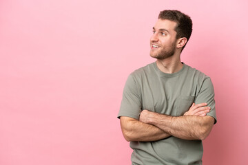 Young caucasian man isolated on pink background happy and smiling