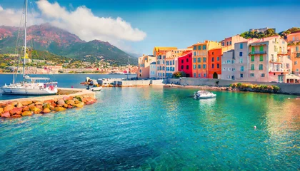 Outdoor kussens colorful houses on the shore of bastia port bright morning view of corsica island france europe magnificent mediterranean seascape with yacht traveling concept background © Nichole