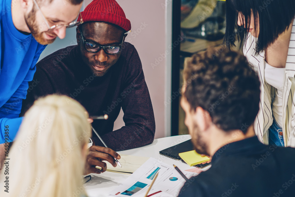 Poster crew of multiracial employees cooperating during brainstorming session solving problems