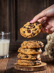 Cookies are stacked neatly on a wooden placemat, isolated with a wooden table background.