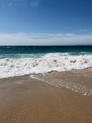 Fototapeta na wymiar sandy ocean coast, waves ocean, blue horizon, natural ocean shore background
