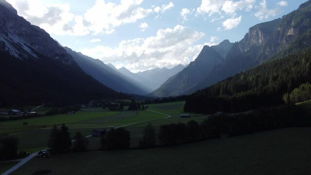 Mountains in Austria at the Brenner Pass at dusk with meadows and forests in 4k