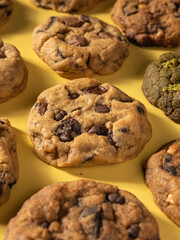 Cookies are neatly arranged in rows, isolated with a yellow background.