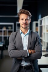 Fototapeta premium Portrait of a businessman with an out of focus office background. Banner, website header, marketing material.