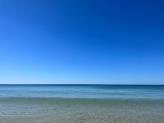Fototapeta na wymiar Transparent blue sea water, blue sea horizon, pure sky, natural blue seascape background