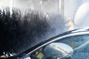 The car washing machine in the city is washing the car