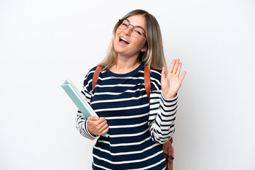 Young student Rumanian woman isolated on white background saluting with hand with happy expression