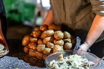 Baked unpeeled potatoes on a baking sheet.
